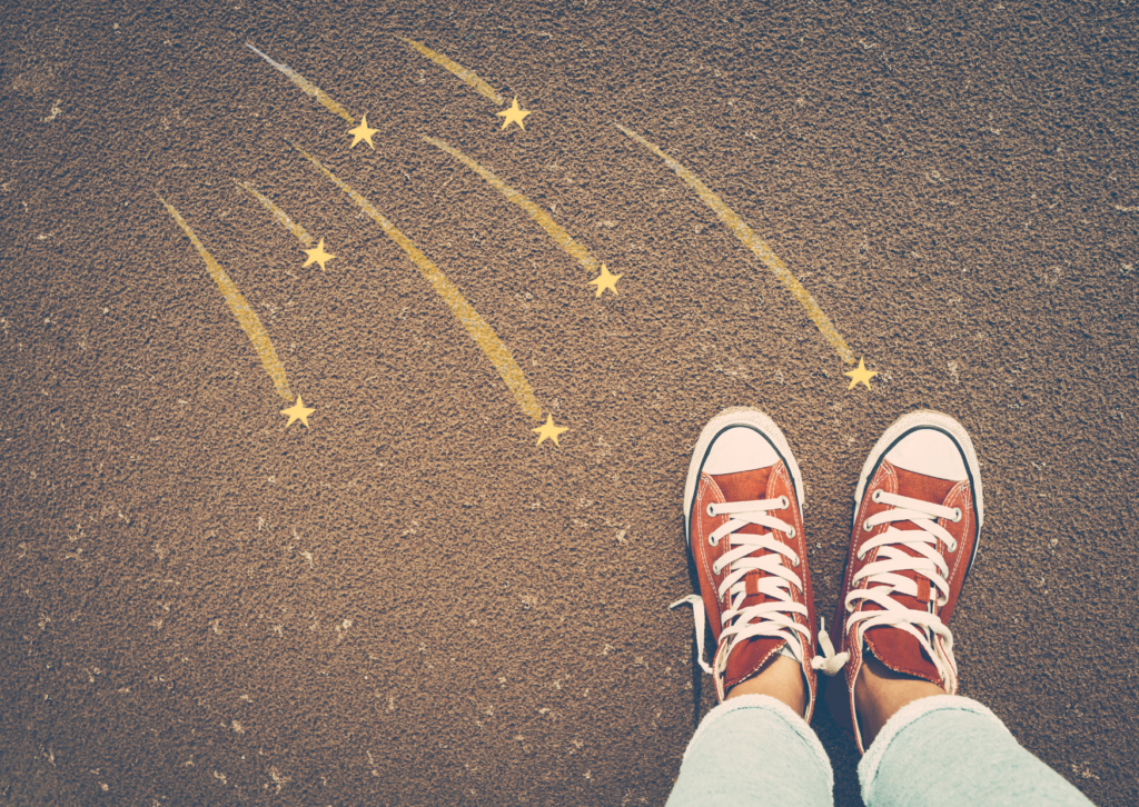 Unge ben i Converse-sko står på bakken, med tegnede stjerneskudd som treffer skoene. Olafprisen vil hedre selvmordsforebygging blant unge.
